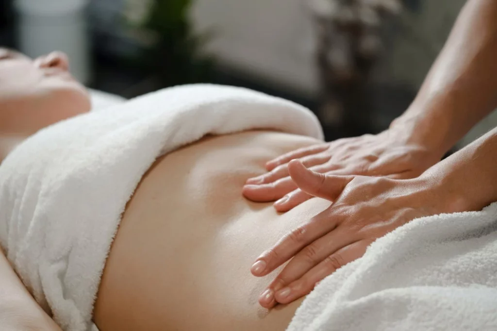 Fundal massage: a postpartum technique showing abdomen pressure to support uterine contraction after childbirth