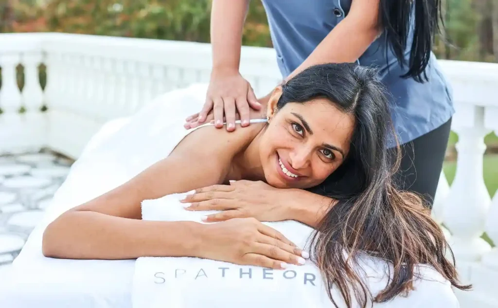 Spa Membership - Monthly Massage Membership Woman enjoying a relaxing massage outdoors.